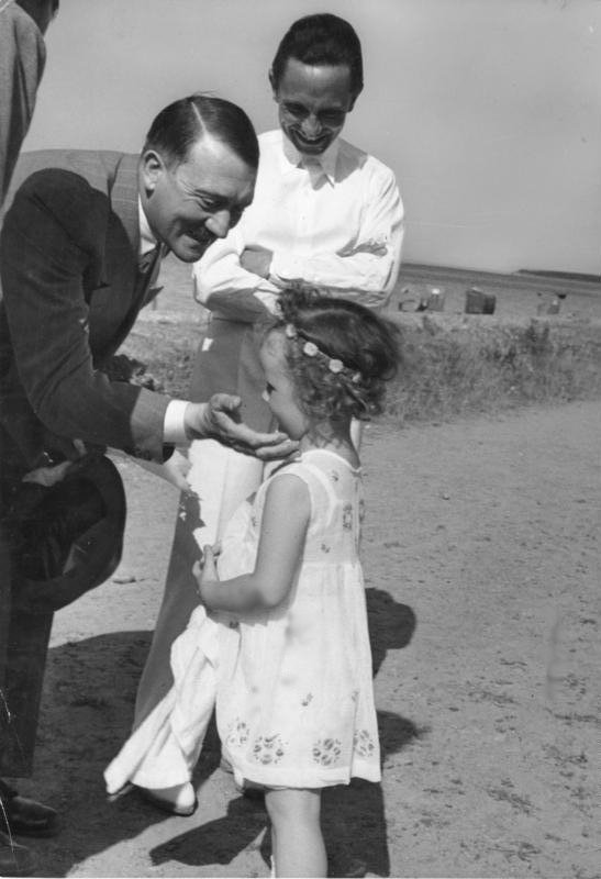 Adolf Hitler, Joseph Goebbels, and his daughter Helga on the beach in Heiligendamm